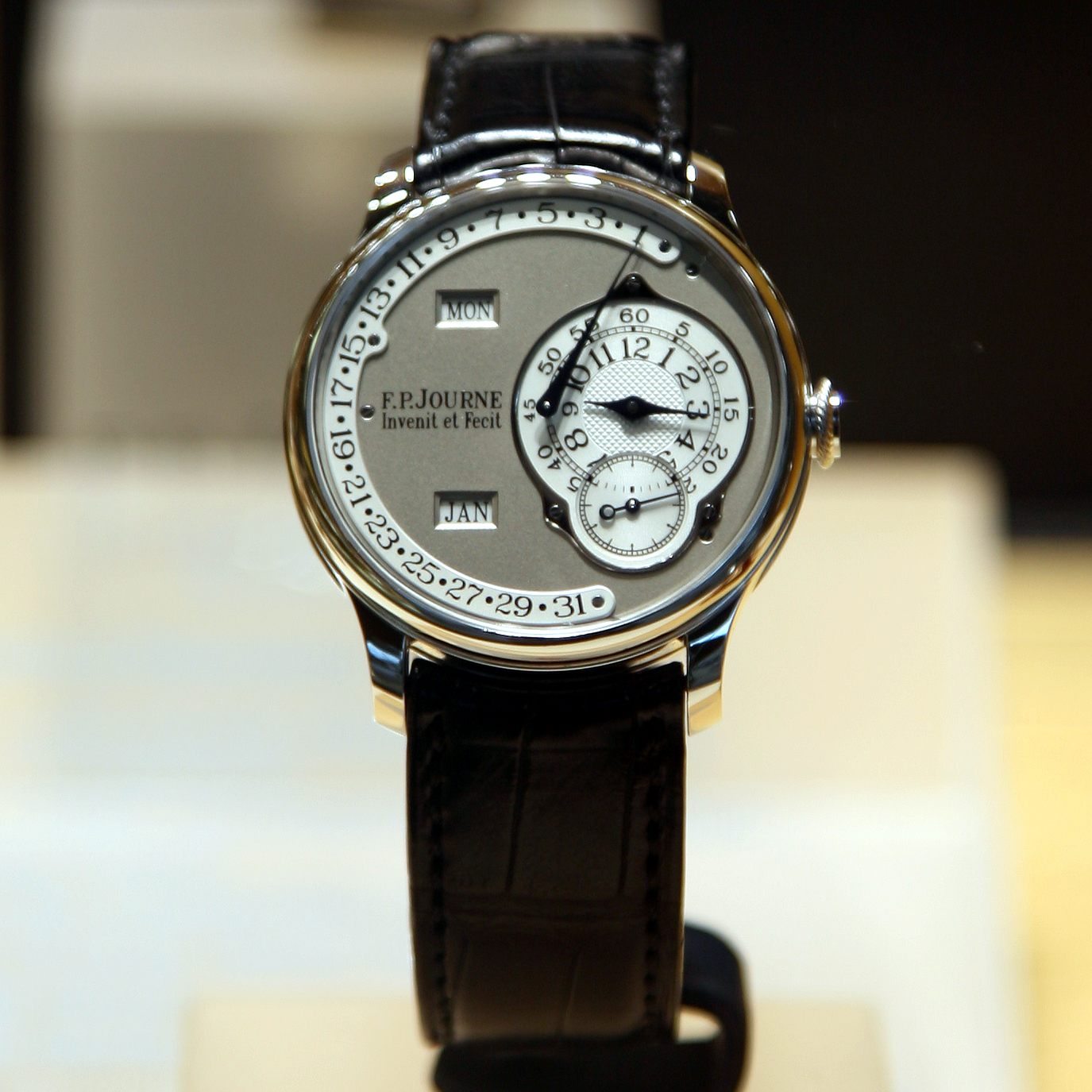 An F.P. Journe wristwatch with day, date and month displays on a black leather strap — F.P. Journe was among the strongest results at October's auction sales